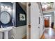 Elegant powder room with pedestal sink, wood floors, and stylish decor at 2368 Glynn Se Dr, Atlanta, GA 30316