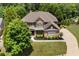 Aerial view of a beautiful home with lush landscaping, a sparkling pool, and a well-manicured lawn at 307 Heritage Overlook, Woodstock, GA 30188