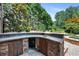 Backyard featuring an outdoor kitchen with wood doors and a stone counter at 307 Heritage Overlook, Woodstock, GA 30188