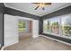 Cozy bedroom with large windows and a built-in bookshelf leading to a separate room at 307 Heritage Overlook, Woodstock, GA 30188