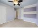 Bedroom with doors and stripe accent wall with neutral carpet at 307 Heritage Overlook, Woodstock, GA 30188