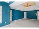 Spacious bedroom with plush carpet, a tray ceiling with fan, and a private entry to the backyard at 307 Heritage Overlook, Woodstock, GA 30188