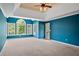 Primary bedroom suite with tray ceiling and access to a private outdoor balcony at 307 Heritage Overlook, Woodstock, GA 30188