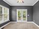 Bedroom with neutral carpet, a ceiling fan, and a door leading to a private outdoor balcony at 307 Heritage Overlook, Woodstock, GA 30188
