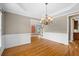 Open dining room with elegant chandelier, seamlessly connected to other living areas in this home at 307 Heritage Overlook, Woodstock, GA 30188