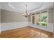 Dining room with large window and classic wainscoting, enhancing the elegance of the room at 307 Heritage Overlook, Woodstock, GA 30188