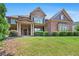 Beautiful two-story home with manicured lawn, brick and stone accents, and covered porch enhancing curb appeal at 307 Heritage Overlook, Woodstock, GA 30188