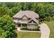 Stunning two-story brick home featuring a manicured lawn and lush landscaping at 307 Heritage Overlook, Woodstock, GA 30188