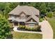 Charming home with manicured lawn and lush landscaping, complemented by a grey-tone roof at 307 Heritage Overlook, Woodstock, GA 30188