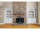 Living room with a stone fireplace and built-in shelves, perfect for a cozy atmosphere at 307 Heritage Overlook, Woodstock, GA 30188