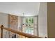 Open foyer overlooking a pool and fireplace, enhanced by tall windows and abundant natural light at 307 Heritage Overlook, Woodstock, GA 30188