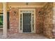 Charming front entrance with brick facade, stone accents, and elegant lighting fixtures creating curb appeal at 307 Heritage Overlook, Woodstock, GA 30188