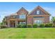 Charming two-story brick home with stone accents and a well-manicured lawn at 307 Heritage Overlook, Woodstock, GA 30188