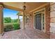 A welcoming front porch featuring brick floors and decorative pillars and stone accents at 307 Heritage Overlook, Woodstock, GA 30188
