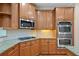 Modern kitchen featuring stainless steel appliances, granite countertops, and custom cabinetry at 307 Heritage Overlook, Woodstock, GA 30188