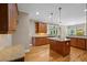Open kitchen with granite countertops, stainless steel appliances, and a kitchen island at 307 Heritage Overlook, Woodstock, GA 30188