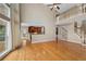 Bright living room with hardwood floors, fireplace, and open kitchen and staircase to the second floor at 307 Heritage Overlook, Woodstock, GA 30188
