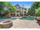 Backyard pool, firepit, and patio with outdoor seating create a resort-like atmosphere for leisure and enjoyment at 307 Heritage Overlook, Woodstock, GA 30188