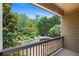 Inviting backyard view of the pool surrounded by lush greenery from a covered patio at 307 Heritage Overlook, Woodstock, GA 30188