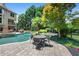 Beautiful backyard pool with patio seating and lush landscaping, perfect for outdoor entertaining at 307 Heritage Overlook, Woodstock, GA 30188