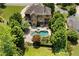 Aerial view of a backyard oasis with a pool, spa, patio, and lush greenery at 307 Heritage Overlook, Woodstock, GA 30188