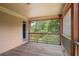 Screened porch featuring wooden floors, wood trim, and an open view of the wooded outdoors at 307 Heritage Overlook, Woodstock, GA 30188