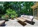 Relaxing back deck with comfortable couch and vibrant flower planters, offering a serene outdoor living space at 1020 Matheson Way, Johns Creek, GA 30022