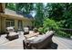 Inviting back deck with cozy wicker furniture, perfect for outdoor relaxation and entertaining amidst lush greenery at 1020 Matheson Way, Johns Creek, GA 30022