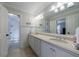 Bright bathroom featuring double sinks, white cabinets and a view of shower and water closet at 1020 Matheson Way, Johns Creek, GA 30022