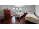 Bright bedroom with two beds, hardwood floors, transom windows, and neutral decor at 1020 Matheson Way, Johns Creek, GA 30022