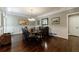 Formal dining room with hardwood floors, wainscoting and elegant chandelier at 1020 Matheson Way, Johns Creek, GA 30022