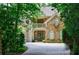 Charming stone and stucco home with inviting balcony and lush landscaping at 1020 Matheson Way, Johns Creek, GA 30022