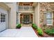 Welcoming front entrance with double doors, sconces, and manicured landscaping at 1020 Matheson Way, Johns Creek, GA 30022
