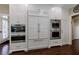 Modern kitchen featuring stainless steel appliances, custom cabinets, and hardwood floors at 1020 Matheson Way, Johns Creek, GA 30022