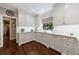 Elegant kitchen with white cabinetry, hardwood floors, and marble countertops at 1020 Matheson Way, Johns Creek, GA 30022