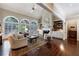 Spacious living room with large windows, fireplace, and built-in shelving at 1020 Matheson Way, Johns Creek, GA 30022