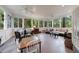 Relaxing sunroom with tile floors, ceiling fans and walls of windows at 1020 Matheson Way, Johns Creek, GA 30022
