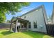 Beautiful backyard featuring an outdoor patio with ceiling fan and lush, green lawn at 1878 Weston Ln, Tucker, GA 30084
