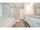 Bathroom featuring a shower with white tile, a garden tub and double vanity at 1878 Weston Ln, Tucker, GA 30084