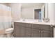 Bathroom featuring double vanity, modern gray cabinets, tiled floors, and a shower-tub combo at 1878 Weston Ln, Tucker, GA 30084