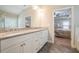 Well-lit bathroom features double vanity with granite countertop and gray slate tile flooring at 1878 Weston Ln, Tucker, GA 30084