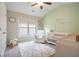 Bright Bedroom with white crib, rocking chair, soft rug, and natural light from the window at 1878 Weston Ln, Tucker, GA 30084