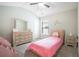Cozy bedroom features a pink bed, vaulted ceiling, and ample natural light from the window at 1878 Weston Ln, Tucker, GA 30084