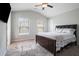 Bedroom featuring a queen bed, carpet, vaulted ceiling, and natural light from the windows at 1878 Weston Ln, Tucker, GA 30084
