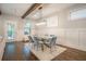 Dining area with modern light fixture, wood floors, and bright natural light at 1878 Weston Ln, Tucker, GA 30084