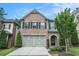 Two-story brick home featuring a two-car garage and well-maintained landscaping at 1878 Weston Ln, Tucker, GA 30084