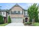 Two-story brick home featuring a two-car garage and well-maintained landscaping at 1878 Weston Ln, Tucker, GA 30084