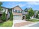 Well-manicured front yard with a brick facade and a two-car garage in suburban community at 1878 Weston Ln, Tucker, GA 30084