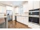 Modern kitchen featuring stainless steel appliances and ample white cabinetry at 1878 Weston Ln, Tucker, GA 30084