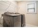 Laundry room features a modern, front load washer and dryer with overhead storage shelf at 1878 Weston Ln, Tucker, GA 30084